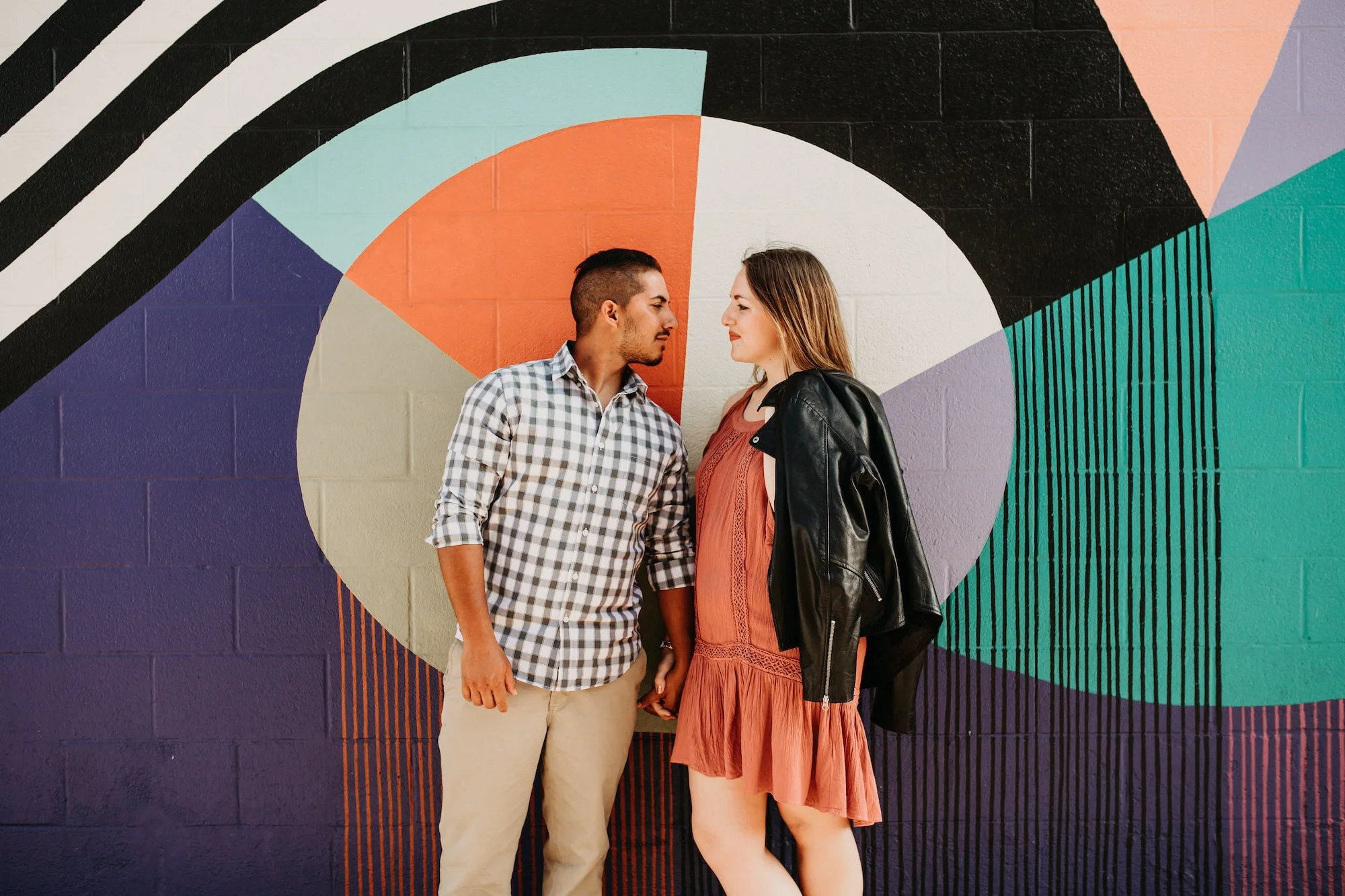 Carley and José in front of an art mural.